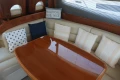 Luxurious interior of 2006 Princess 42 Flybridge Motor Yacht with elegant seating and cushions.