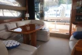 Luxurious interior of 2006 Princess 42 Flybridge Motor Yacht with elegant seating and table.