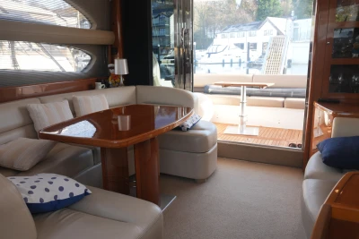 Luxurious interior of 2006 Princess 42 Flybridge Motor Yacht with elegant seating and table.