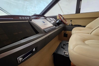 Interior cockpit of 2006 Princess 42 Flybridge Motor Yacht with beige seating.