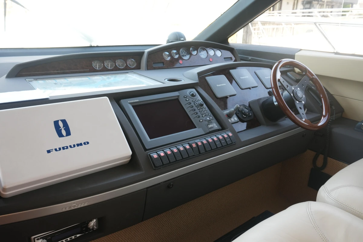 Helm of 2006 Princess 42 Flybridge Motor Yacht with navigation equipment and steering wheel.