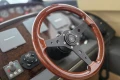 Steering wheel of a 2006 Princess 42 Flybridge Motor Yacht, featuring wood and metal design.