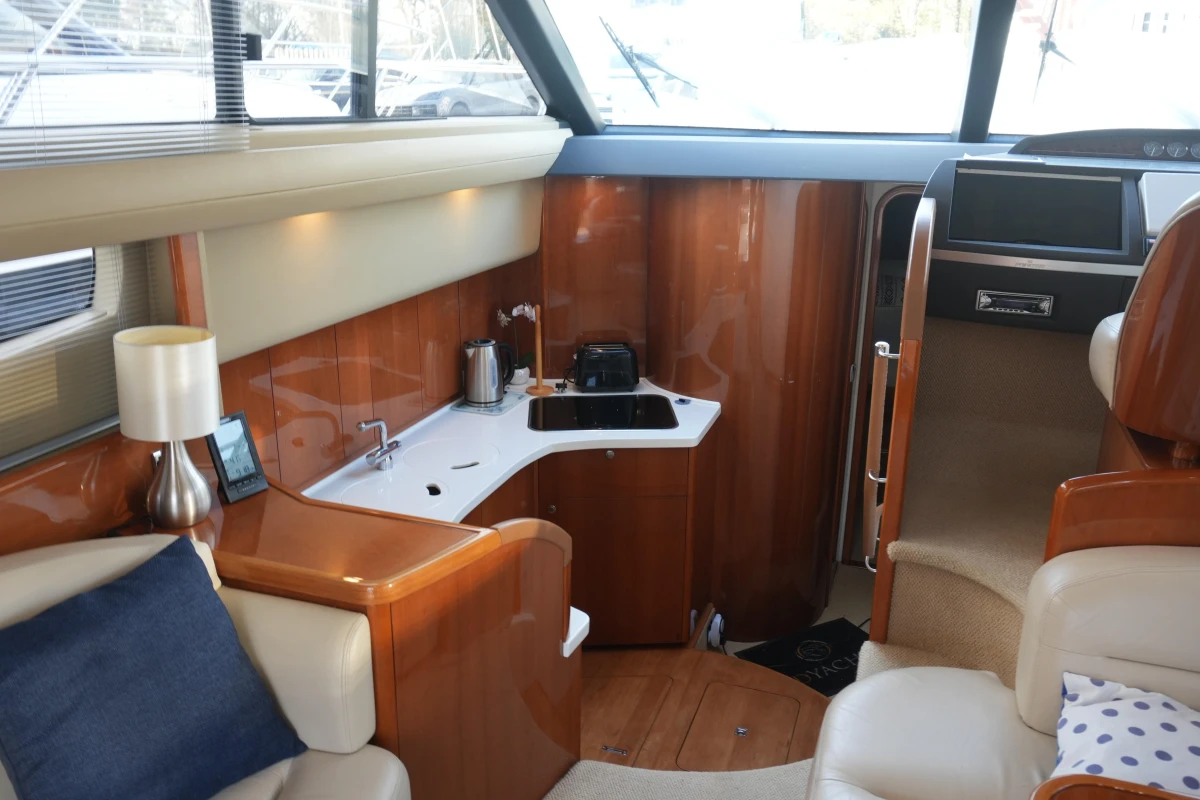 Luxurious interior of 2006 Princess 42 Flybridge Motor Yacht with kitchenette and seating area.
