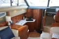 Luxurious interior of 2006 Princess 42 Flybridge Motor Yacht with kitchenette and seating area.