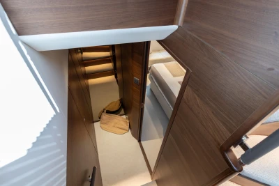 Interior view of 2026 Princess Y72 yacht, featuring elegant wooden finishes and cozy cabin space.