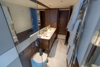 Luxurious yacht bathroom with modern fixtures, wooden cabinetry, and elegant design, Princess Y72 2026 model.