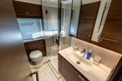 Luxurious bathroom in 2026 Princess Y72 yacht, featuring modern fixtures and elegant wood finishes.