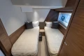Luxurious twin cabin in 2026 Princess Y72 yacht, featuring modern design and cozy bedding.