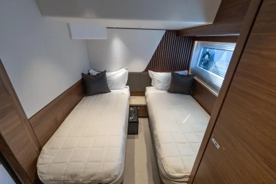 Luxurious twin cabin in 2026 Princess Y72 yacht, featuring modern design and cozy bedding.
