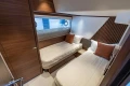 Luxurious twin cabin in 2026 Princess Y72 yacht, featuring modern design and cozy bedding.