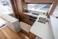 Luxurious kitchen interior of 2026 Princess Y72 yacht with modern appliances and wooden finishes.