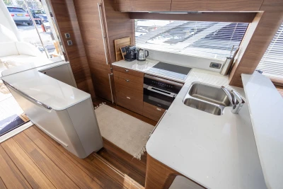 Luxurious kitchen interior of 2026 Princess Y72 yacht with modern appliances and wooden finishes.