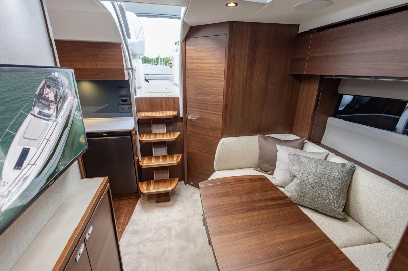 Luxurious interior of 2026 Princess V40 yacht with modern wood finishes and cozy seating.