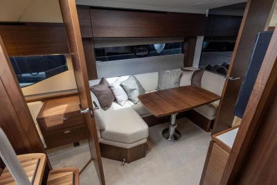 Luxurious interior of 2026 Princess V40 yacht with elegant wood finishes and cozy seating.