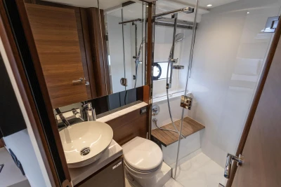 Luxurious bathroom in 2026 Princess V40 yacht with modern fixtures and wooden accents.