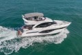 Luxurious 2023 Princess F50 yacht cruising on open water.