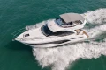 2023 Princess F50 yacht cruising on open water, aerial view.