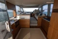 Luxurious interior of 2023 Princess F50 yacht with modern kitchen and seating area.
