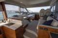 Luxurious interior of 2023 Princess F50 yacht with modern seating and kitchenette.