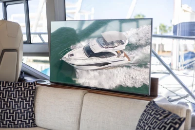 Luxurious 2023 Princess F50 yacht displayed on a screen inside a stylish cabin.