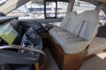 Luxurious interior of 2023 Princess F50 yacht with modern helm and plush seating.