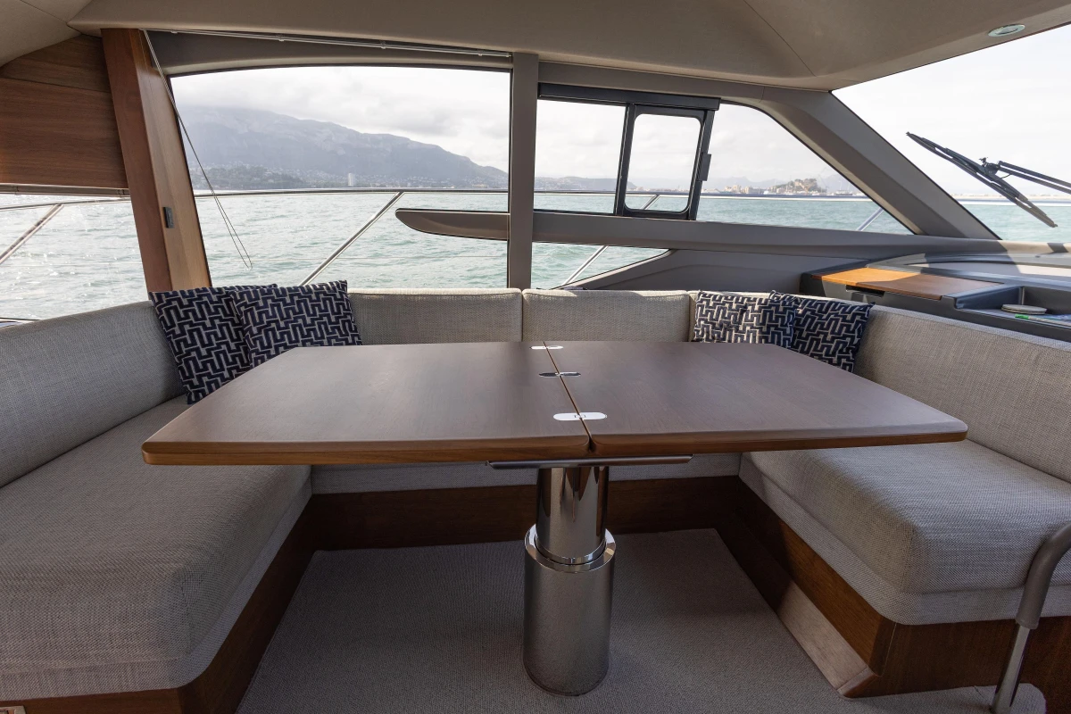 Luxurious interior of 2023 Princess F50 yacht with elegant seating and table.