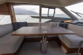 Luxurious interior of 2023 Princess F50 yacht with elegant seating and table.