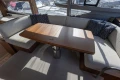 Luxurious interior of 2023 Princess F50 yacht with elegant seating and wooden table.