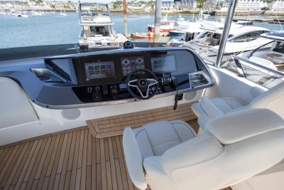 Luxurious cockpit of 2023 Princess S72 yacht with modern helm station.