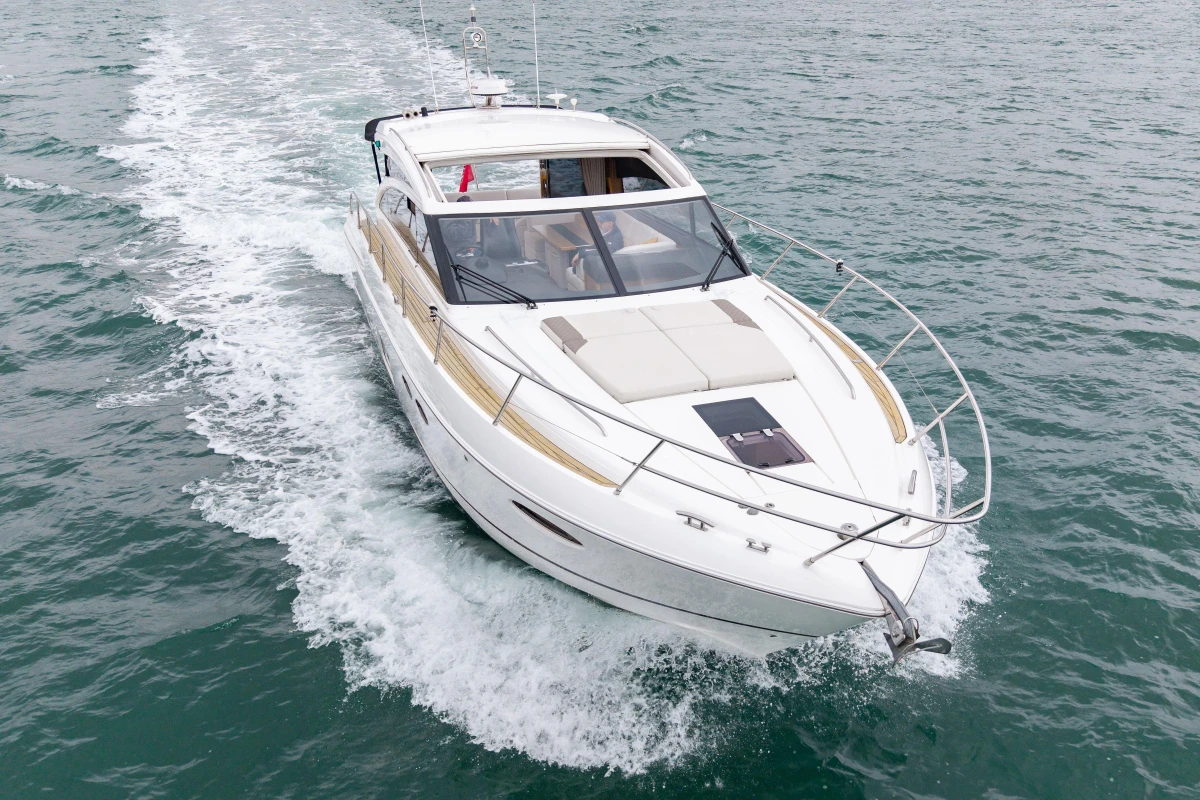 2014 Princess V52 yacht cruising on open water, showcasing sleek design and luxury.