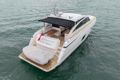Luxury 2014 Princess V52 yacht cruising on open water, rear view.