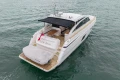 Luxury 2014 Princess V52 yacht cruising on open water, rear view.