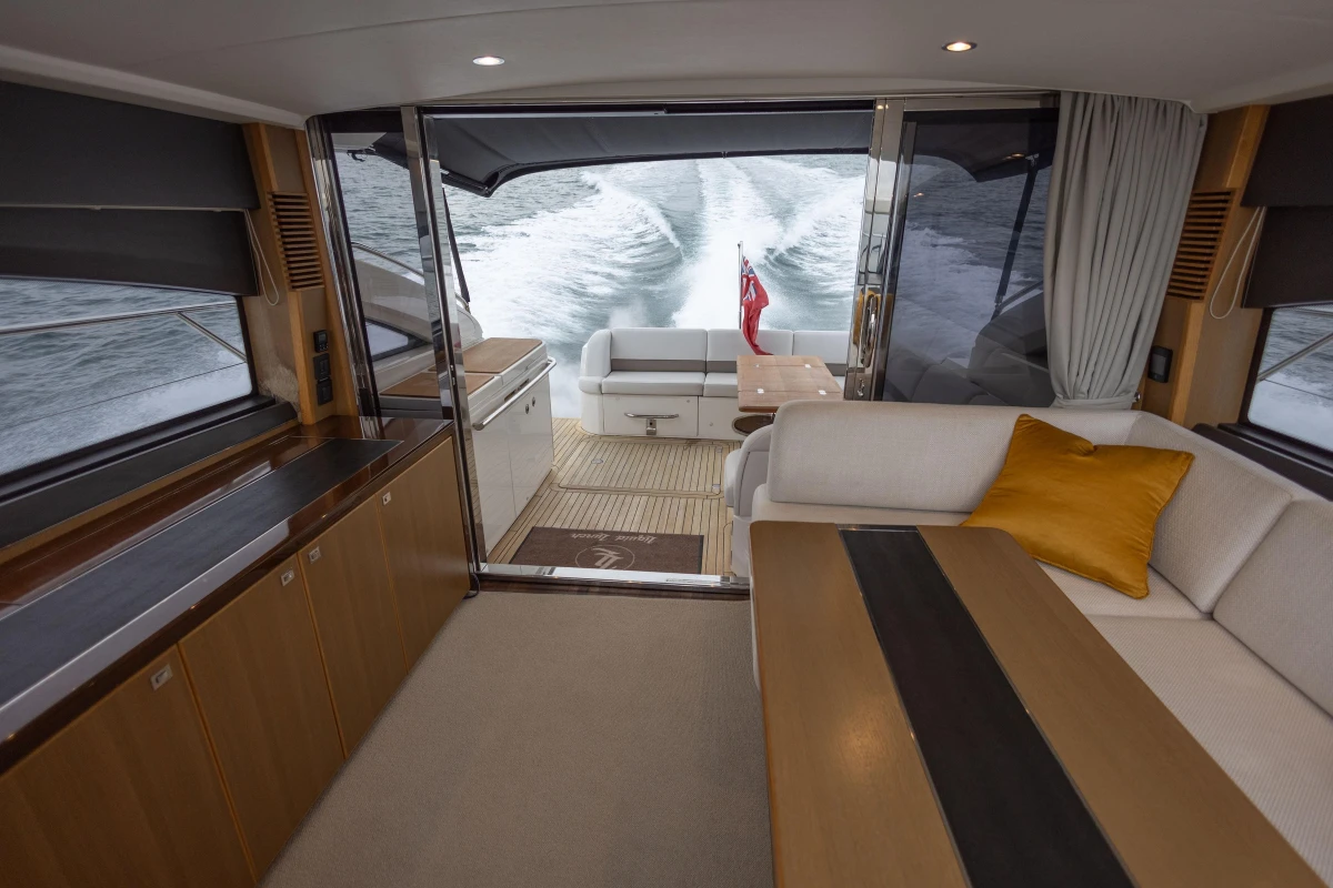 Luxurious interior of 2014 Princess V52 yacht with elegant seating and ocean view.