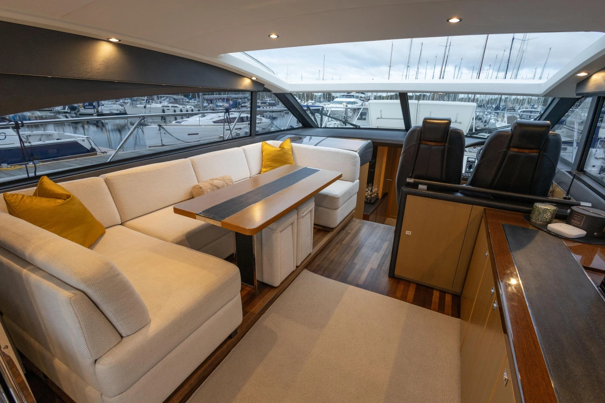 Luxurious 2014 Princess V52 yacht interior with elegant seating, modern design, and marina view.