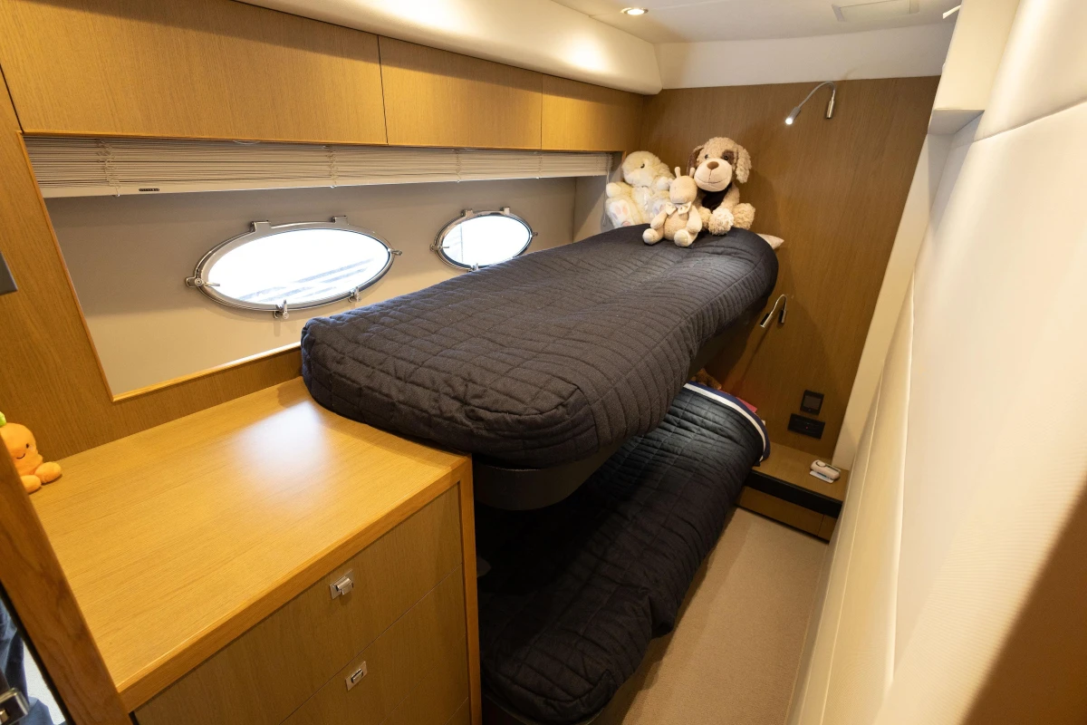 Luxurious 2014 Princess V52 yacht cabin with bunk beds and plush toys.