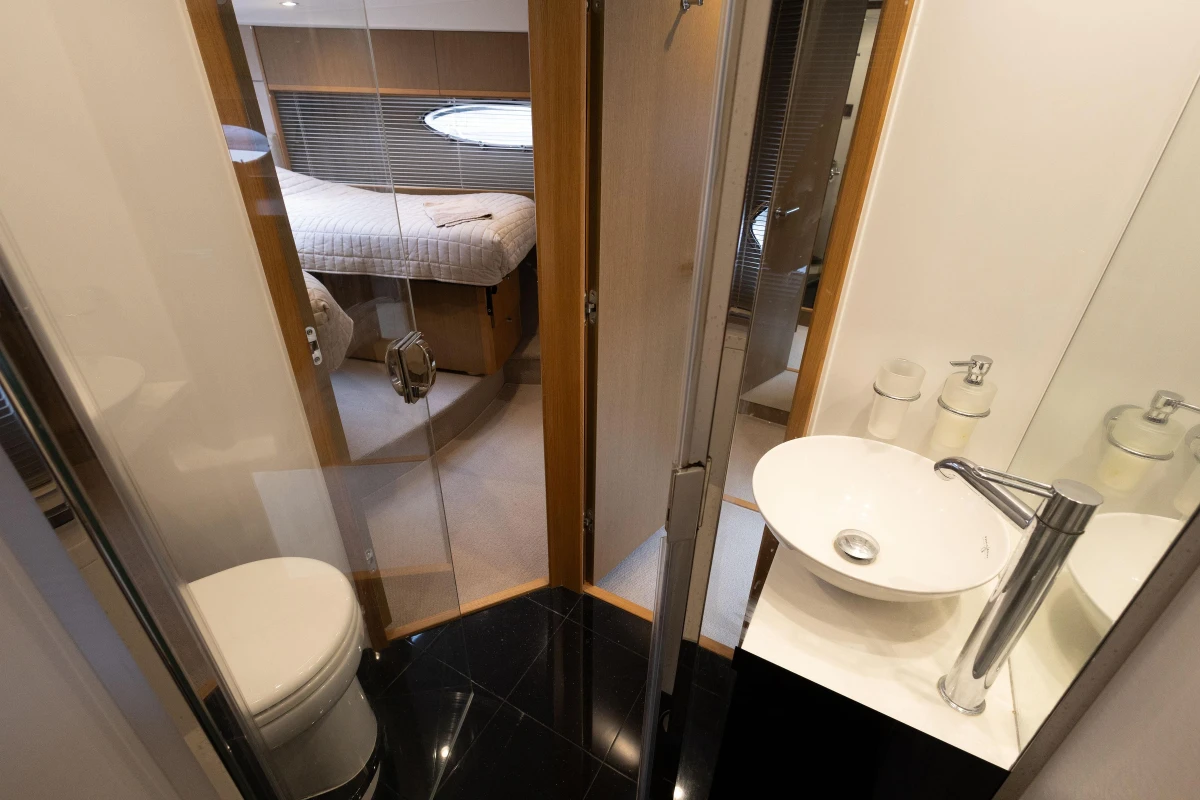 Luxurious 2014 Princess V52 yacht interior with modern bathroom and cozy bedroom.