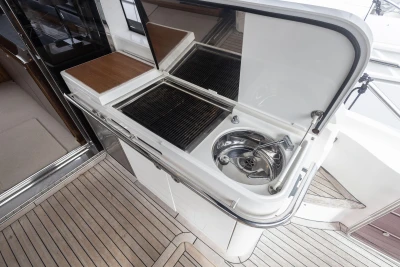 Outdoor kitchenette on 2012 Princess V52 yacht with sink and grill.
