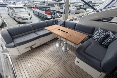 Luxurious 2012 Princess V52 yacht deck with elegant seating and wooden table.