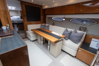 Luxurious interior of a 2012 Princess V52 yacht with elegant seating and dining area.