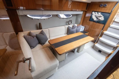 Luxurious interior of 2012 Princess V52 yacht with elegant seating and wooden table.