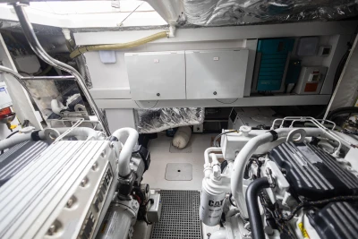 Engine room of 2012 Princess V52 yacht, featuring dual engines and control panels.