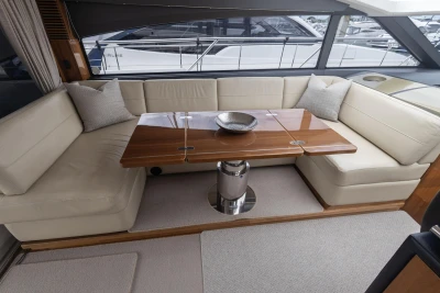 Luxurious interior of 2012 Princess V52 yacht with elegant seating and wooden table.