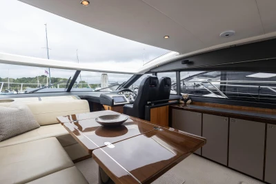 Interior of 2012 Princess V52 yacht with elegant seating and modern helm.