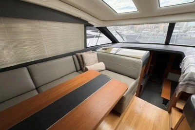 Luxurious interior of a 2013 Princess V52 yacht with elegant seating and wooden table.