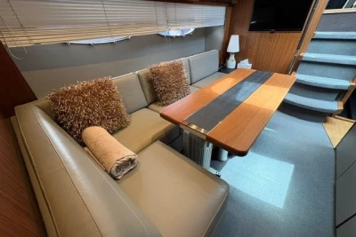 Luxurious interior of 2013 Princess V52 yacht with plush seating and elegant table.