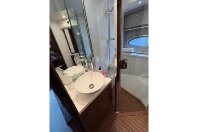 Luxurious bathroom interior of 2013 Princess V52 yacht with modern fixtures and wooden flooring.