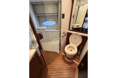 Luxurious bathroom on 2013 Princess V52 yacht with wooden flooring and modern fixtures.