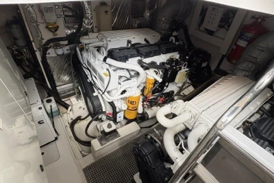 Engine room of a 2013 Princess V52 yacht, featuring a CAT engine and organized layout.