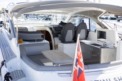 2017 Princess V40 yacht interior with seating, table, and helm, docked at marina.