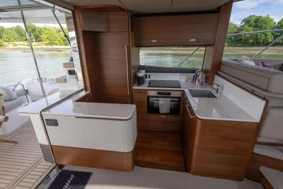 Interior view of the Princess F55 yacht with a modern kitchen and sleek wood accents.